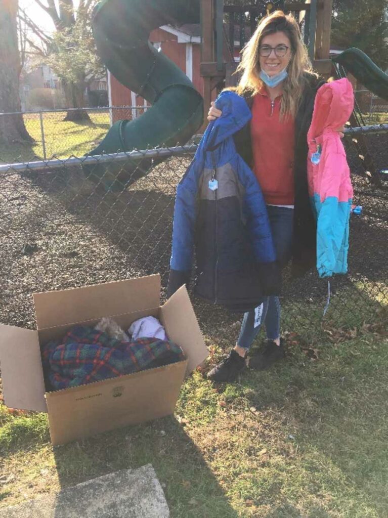 Victoria, Grace House staff, receiving “Coats for Kids”