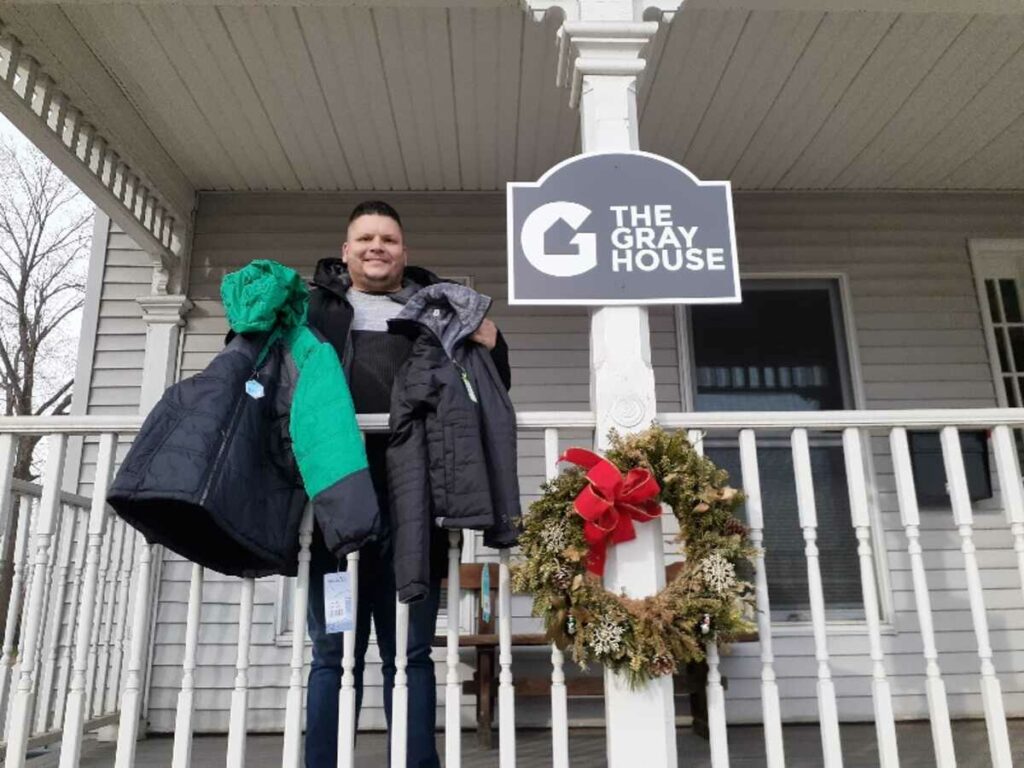 Staff member at The Gray House, receiving “Coats for Kids”