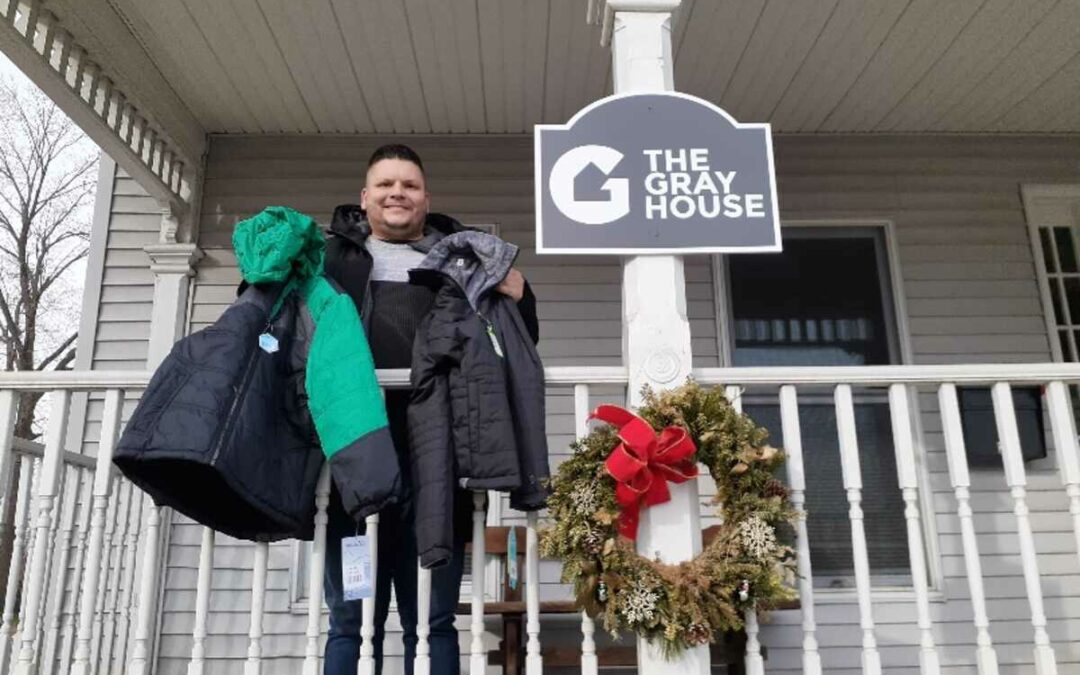 Staff member at The Gray House, receiving “Coats for Kids”