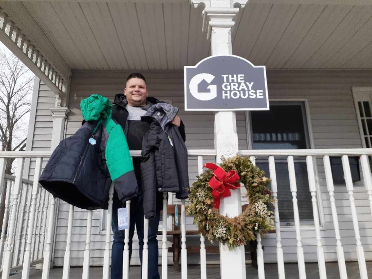 Staff member at The Gray House, receiving “Coats for Kids”